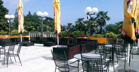 Historische Geb&auml;udeansicht des Hotels Opatija mit dekorativen Balkonen und wei&szlig;en Fenstern auf gelber Au&szlig;enfassade