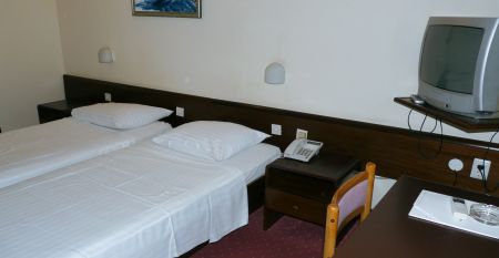 Historische Geb&auml;udeansicht des Hotels Opatija mit dekorativen Balkonen und wei&szlig;en Fenstern auf gelber Au&szlig;enfassade