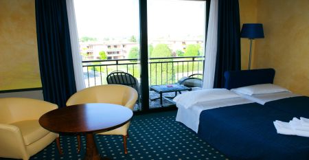Au&szlig;enansicht des Hotels Villa Maria mit Balkonen, gepflegtem Garten und mehreren Nationalflaggen vor dem Geb&auml;ude