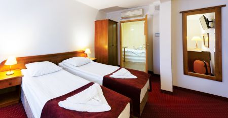 Au&szlig;enansicht des modernen Geb&auml;udes des Hotel Zawisza am Abend, beleuchtet am Wasserufer.